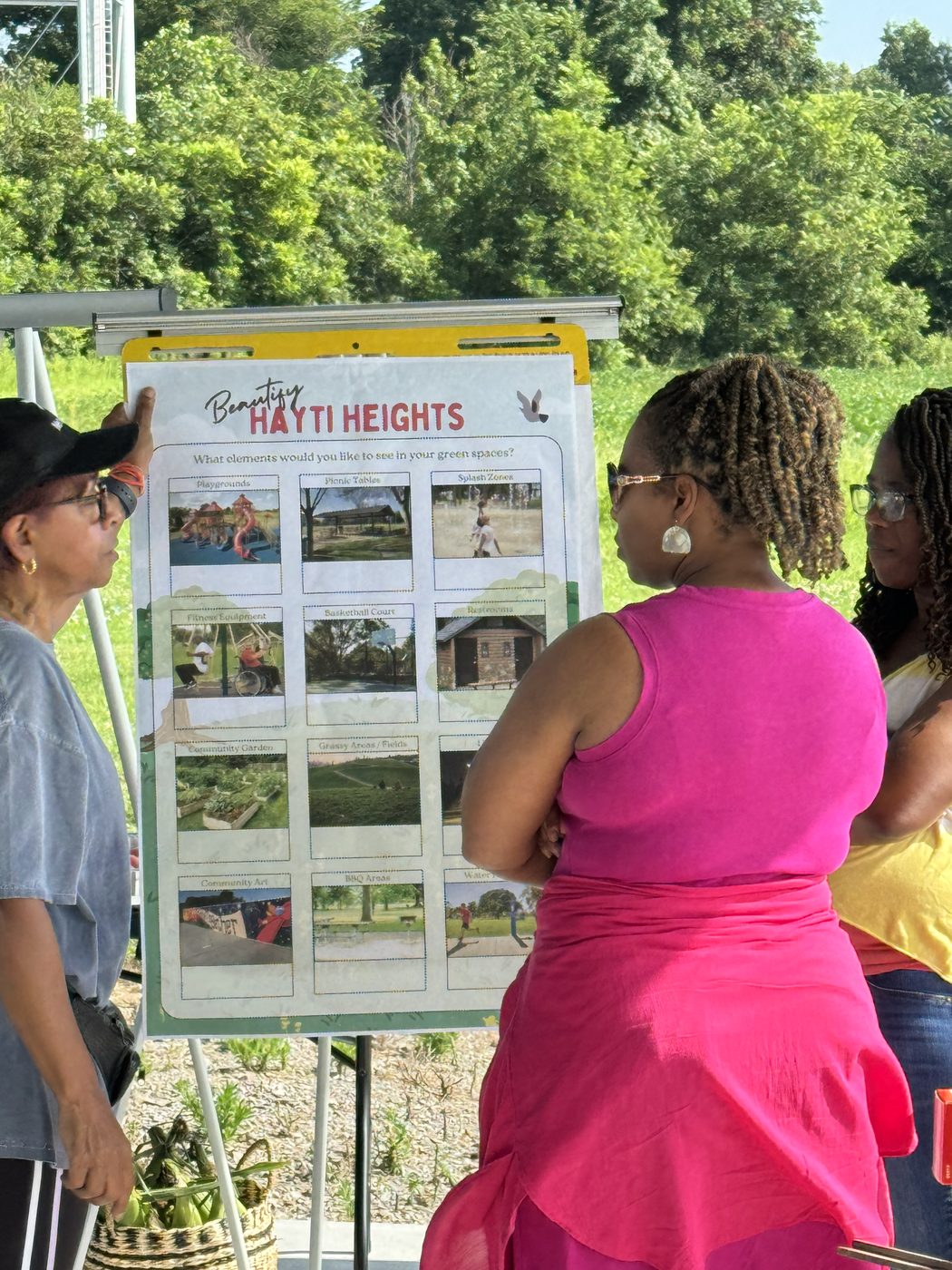 Community members sharing ideas on the Beautify Hayti Heights board