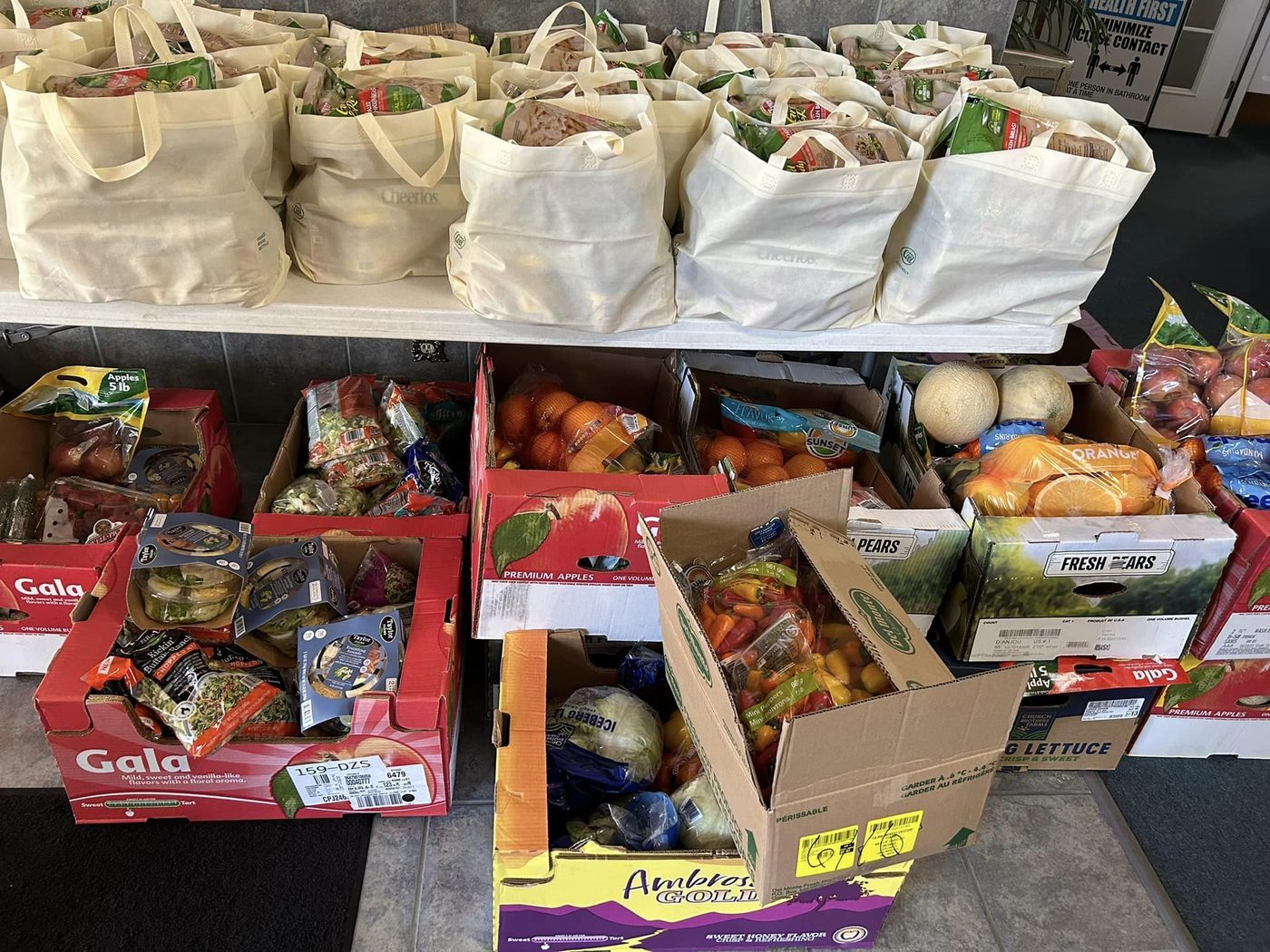 Fresh produce boxes and bagged food ready for distribution